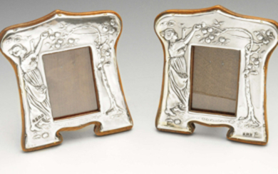 A matched pair of Edwardian silver mounted photograph frames.