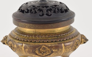 18th century Chinese gilt bronze small censer. Foo lion mask handles. Floral stippled ground panels.