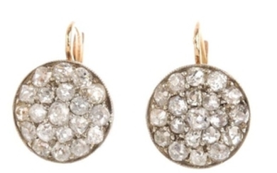 A pair of diamond earrings. Each of circular outline