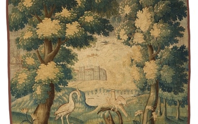 A Flemish Verdure tapestry, embroidered with heron and cockatoo between trees, background with castle. 18th century first half. 197×191 cm.