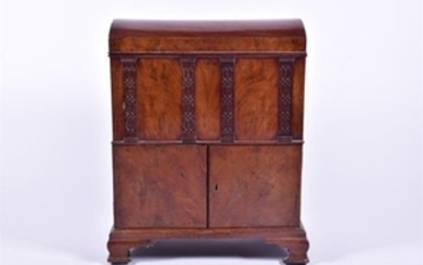 A Victorian mahogany and burr walnut veneered cellarette the dome shaped lid opening to reveal a felt lined fitted interior...