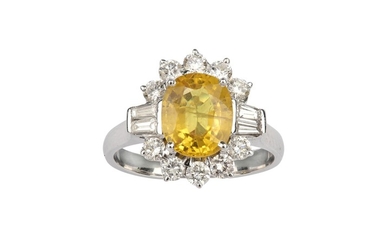 A yellow sapphire and diamond cluster ring The...