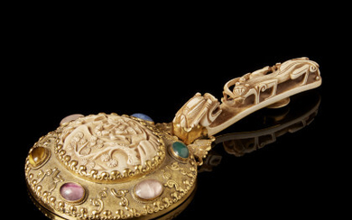 A mirror composed by an ivory handle carved as dragon, and with a further ivory plaque and embellished with inset...