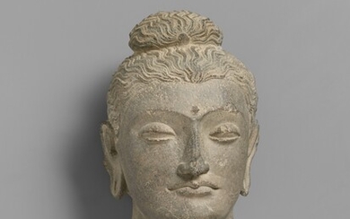 A large and elegant Gandhara grey schist head of a Buddha. 2nd/3rd century