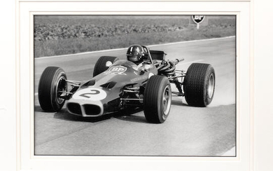 A framed photograph of Graham Hill in the Lotus 59B