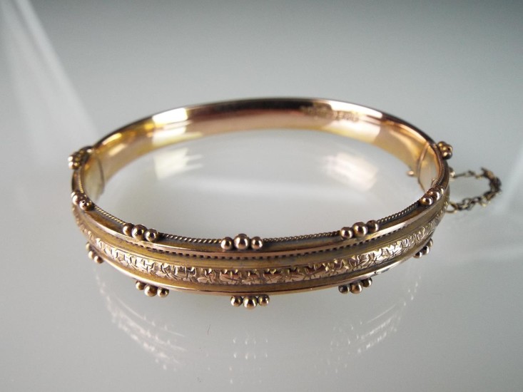 9ct Fancy gold Bangle with safety chain. 9.3g