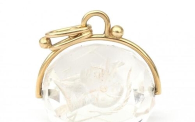 A 14 karat gold quartz fob swivle pendant. Three different intaglio sides. Gross weight: 8.3 g.