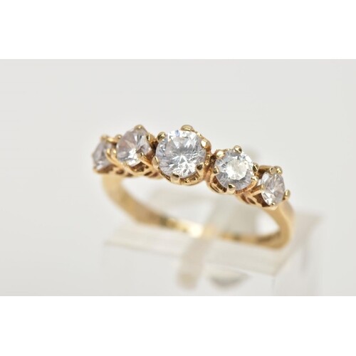 A 15CT GOLD CUBIC ZIRCONIA DRESS RING, designed with a row o...