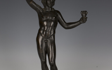 A 19th century Grand Tour darkly patinated cast bronze figure of Bacchus, holding a bunch of grapes