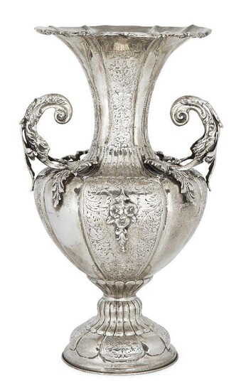 A 19th century twin-handled Continental vase, apparently unmarked, assumed silver, the lobed baluster-shaped body applied with twinned leaves and floral swags to a fluted neck with shaped rim, the vase raised on a lobed circular foot chased with...