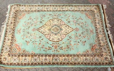 A 20TH CENTURY INDIAN CARPET, green ground with floral