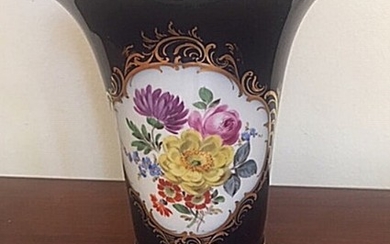 A 20th century Meissen porcelain vase, decorated in colours and gold with flowers in cartouche. H. 16 cm.