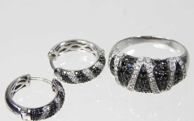 A 9 carat white gold, black and white diamond ring,...