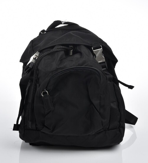 A BACKPACK BY PRADA-Styled in black nylon with silver metal hardware, 22 x 23 x 16cm.