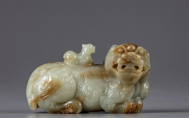 A CHINESE CELADON AND RUSSET JADE BUDDHIST LION WATER
