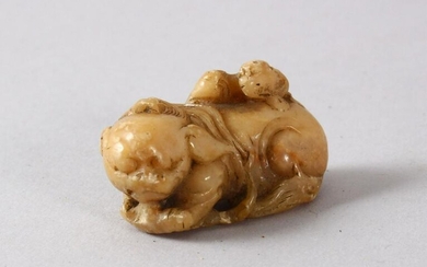 A CHINESE SOAPSTONE FIGURE OF A LION DOGs, the small