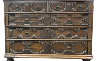 A Charles II joined oak geometric panel fronted chest of drawers