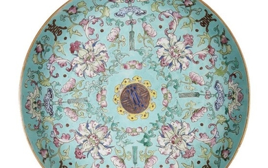 A Chinese porcelain 'sanduo' dish, 19th century, painted in famille rose enamels on a turquoise ground with lotus blooms and meandering leafy scrolls interspersed with bats and Buddhist chimes, all encircling a central shou character, the underside...