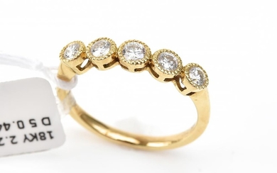 A DIAMOND ETERNITY RING - Set with five round brilliant cut diamonds totalling 0.44ct, in 18ct gold, ring size N.
