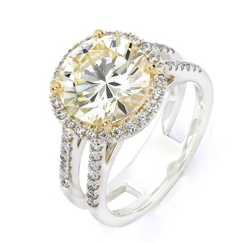 A DOUBLE SHANK HALO DIAMOND ENGAGEMENT RING A Double Shank H...