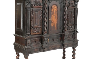 A Flemish darkstained walnut Baroque cabinet, richly carved with masks and foliage. Partly 17th century. H. 187. W. 158. D. 58 cm.
