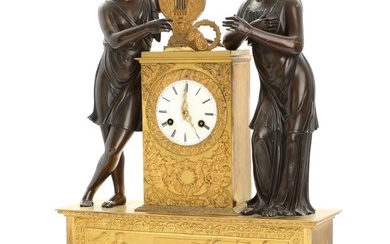 A French partly patinated and gilt bronze Empire mantel clock, surmounted by Apollo and muse. 19th century first half. H. 63 cm.