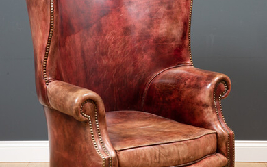 A George II style leather upholstered wing back armchair
