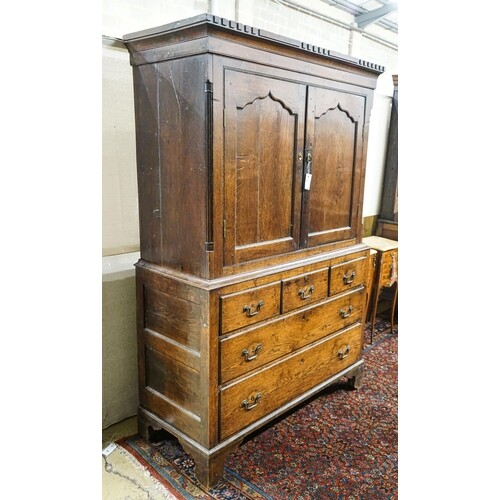 A George III oak press cupboard, with moulded cornice and tw...