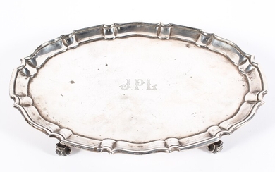 A George V silver footed salver of oval form with pie crust border