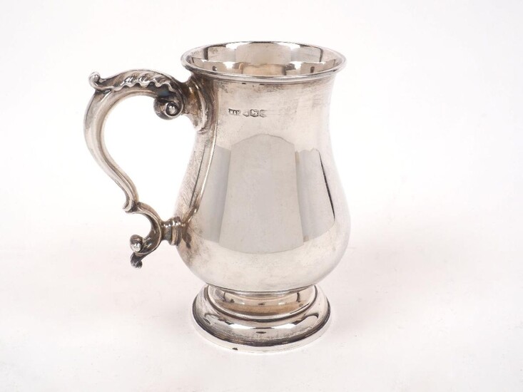 A George VI silver tankard, Sheffield, 1967, Walker & Hall, of plain baluster form with acanthus tipped double scroll handle, 14 cm high, approx. weight 10oz