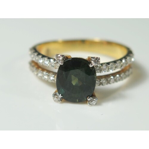 A Green Sapphire and Diamond Ring in an unmarked gold settin...