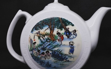 A Korean teapot with village scenery designs