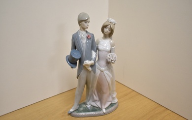 A Lladro porcelain figure group Wedding Day number 1404, modelled as a bride and groom, printed