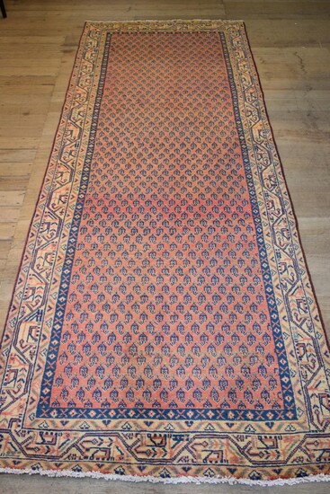 A PERSIAN MIR SERABAND HALL RUNNER. 100% WOOL PILE. HAND-KNOTTED & WITH TRADITIONAL DESIGN OF ALL-OVER PAISLEY PATTERNS SET WITHIN A...