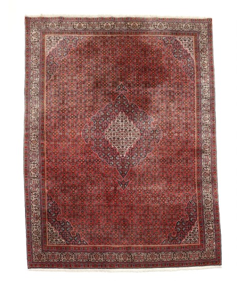 A Persian Bidjar carpet, classic angular medallion design with herati pattern on red base. 20th century second half. 364×257 cm.