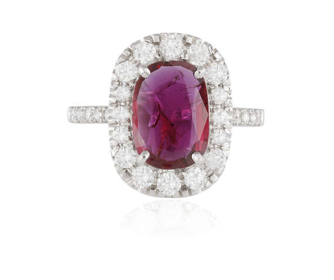 A RUBY AND DIAMOND CLUSTER RING The elongated...