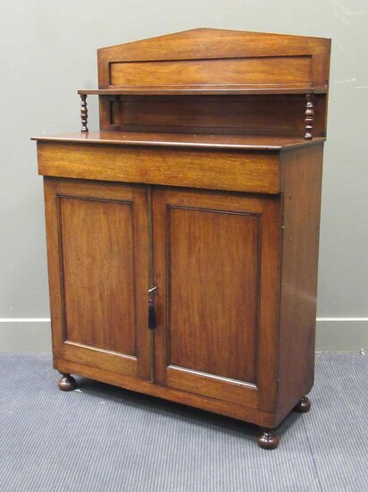 A Regency mahogany cathedral arch raised back chiffonier over a frieze drawer and two door