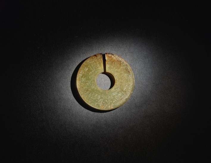 A SUPERB AND RARE ARCHAIC CELADON AND RUSSET JADE SLIT DISC (JUE) EASTERN ZHOU DYNASTY