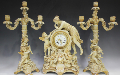 A Sitzendorf porcelain blush ivory clock garniture, late 19th/early 20th century, the clock surmount