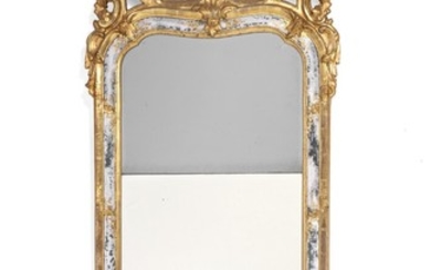 A Swedish Rococo giltwood mirror, top and bottom with openwork rocailles and foliage, the frame with mirrored border. Mid-18th century. H. 153 cm. W. 67 cm.