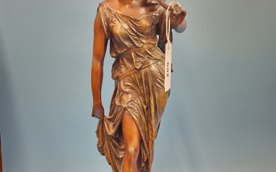 A TABLE LAMP SUPPORTED BY THE SPELTER FIGURE OF A CLASSICAL LADY HOLDING A FLOWERING STEM TO HER