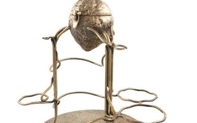 A Victorian electroplated lemon squeezer, by Hukin and Heath, also marked with a registration number, modelled as a lemon, with a hinged cover and turning screw, on three wirework legs with a wire-work frame, on a textured circular base, height 31cm.