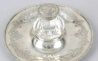 A Victorian silver inkstand with central glass ink pot.