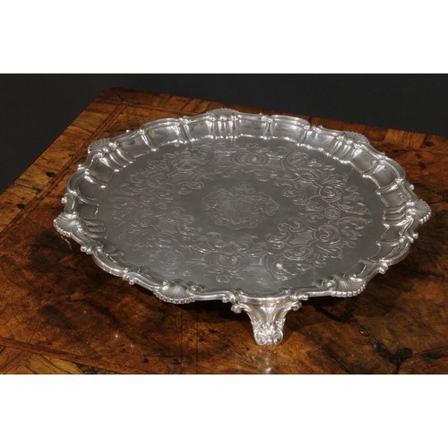 A Victorian silver shaped circular salver, fluted shell and ...