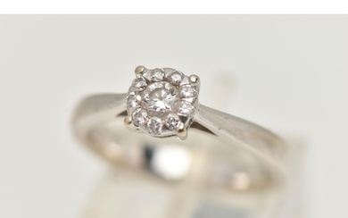 A WHITE METAL DIAMOND CLUSTER RING, centrally set with a rou...