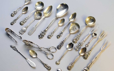 A collection of silver and white metal flatware