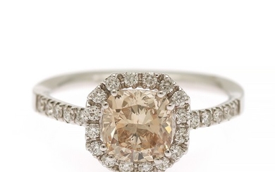 A diamond ring set with a radiant-cut natural orangy yellowish brown diamond weighing 1.35 ct., and diamonds weighing 0.26 ct., mounted in 18k white gold.