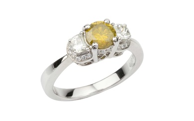 A diamond three stone ring, with central brilliant cut fancy...