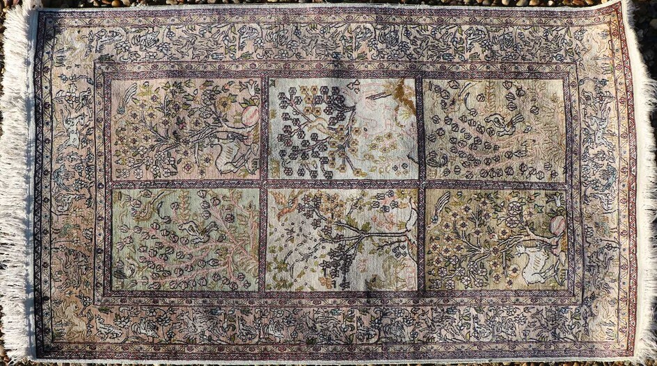 A hand knotted Persian part silk rug