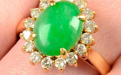 A jade cabochon and brilliant-cut diamond cluster ring.Jade estimated dimensions of 10.7 by 8.3 by